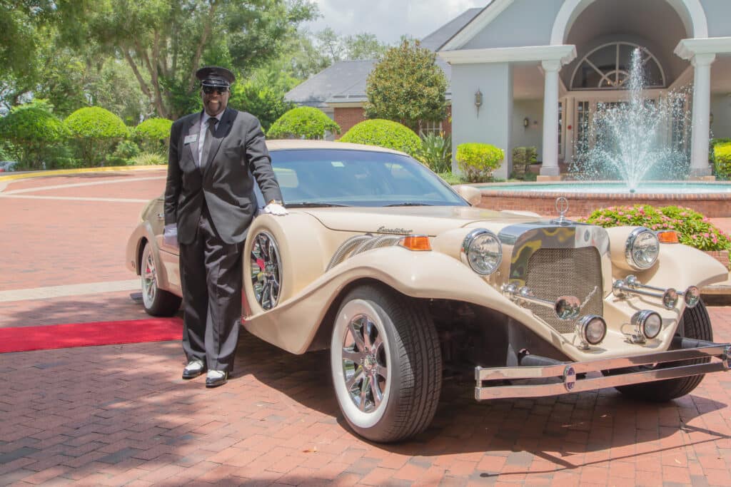 Exotic Limo Orlando chauffer standing with the Excalibur Godfather