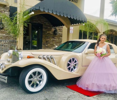 Girl celebrating Quinceañera posing with the Excalibur Godfather by Exotic Limo Orlando