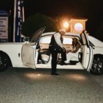 Bride and groom posing in the Rolls Royce Ghost
