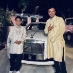 Father and son pose in front of the Rolls Royce Ghost