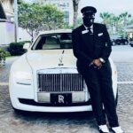 Exotic Limo Orlando Chauffer wearing face mask by the Rolls Royce ghost limousine.
