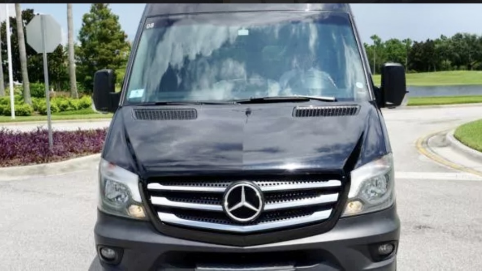 The front view of our Mercedes Sprinter van, showing off the iconic Mercedes-Benz emblem on its grille. The Mercedes passenger van belongs to the Exotic Limo Orlando vehicle fleet. 